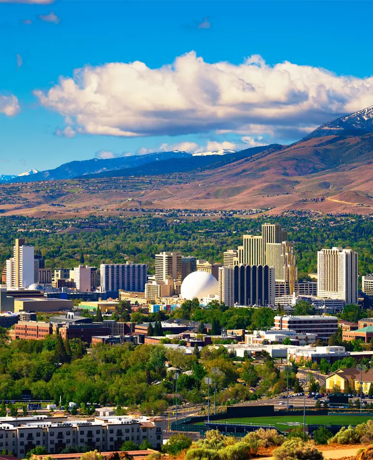 Downtown Reno skyline, Nevada, with hotels, casinos and the surrounding High Eastern Sierra foothills